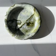 a marble bowl sitting on top of a white counter