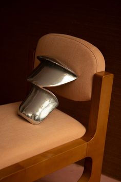 a chair that has some kind of metal object on it's backrests