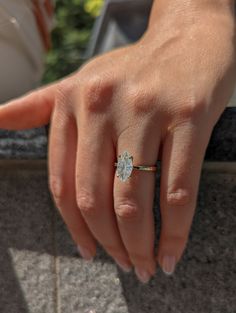 a woman's hand with a diamond ring on it