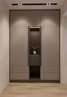 an empty room with two urinals on the wall and some plants in it