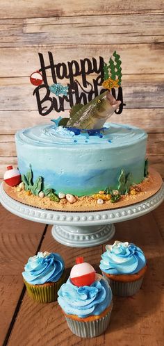 a birthday cake and cupcakes on a table