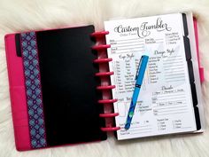 an open planner with a pen on top