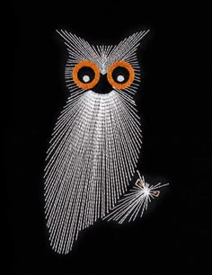 an owl made out of string with orange eyes