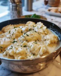 a pot filled with pasta and cheese on top of a table