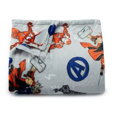 an orange and white blanket with cartoon characters on it's side, sitting in front of a white background