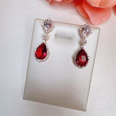 Ruby And Cz Diamond Halo Teardrop Earrings The Pear-Shaped Bold Red Rubies And Oval Shaped Diamonds Are Linked By A Station Diamond Accent. They Are Highlighted By Glittering Diamond Halos. 14k Gold Plated Brass, Cz Diamonds Brand New Gift Ready Hand Painted Beads, Stone Dangle Earrings, Open Hoop Earrings, Luxury Earrings, Diamond Glitter, Daisy Earrings, Red Diamond, Knot Earrings, Ruby Earrings