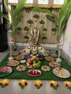 there are many plates on the table with food in front of it and an elephant statue