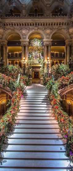 an ornate staircase with christmas decorations and lights