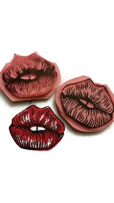 three plates with red and pink lips on them