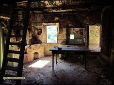 an old run down room with a ladder leaning up against the wall and a window