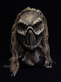 a creepy looking mask with long hair