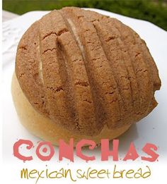 a close up of a doughnut on a plate with the words conchas mexican sweet bread