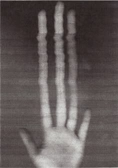 a hand is shown in black and white with blurry lines on it, as well as the palm of an outstretched hand