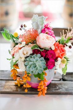 a bouquet of flowers sitting on top of a wooden table next to an instagram page