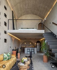 a living room filled with furniture next to a staircase