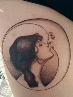 an image of a couple kissing in the moon tattoo on someone's back shoulder