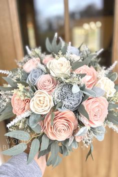 a person holding a bouquet of flowers in their hand