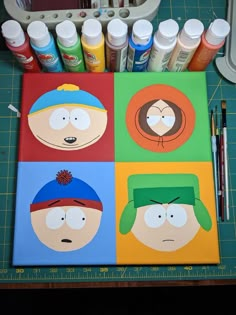 some art supplies are sitting on a cutting board with the faces of cartoon characters painted on them