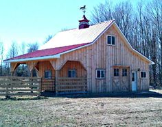 a barn with a red roof and white trim