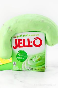 a package of jello sitting on top of a counter next to a green banana