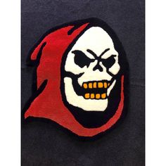 a red and white patch with a skull on it's face in the shape of a head