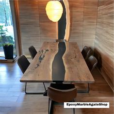 a wooden table with chairs around it in a room that has wood paneling on the walls