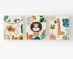 three canvases with animals and plants on them, one has a giraffe, the other is a lion