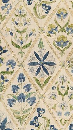 an old wallpaper with blue flowers and green leaves