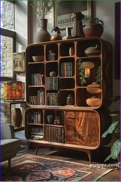 a book shelf with many books and vases sitting on it's sides in front of a window