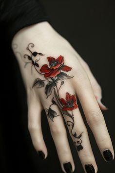 Red and black rose tattoo on the back of a hand. Floral Tattoo Hand, Finger Floral Tattoo, Flower Around Finger Tattoo, Flower Tattoo On Finger For Women, Flower Hand And Finger Tattoo, Butterfly Finger Tattoos, Dark Finger Tattoos, Tattoo Ideas Female Red Ink, Dark Finger Tattoos For Women