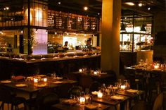 a dimly lit restaurant with many tables and chairs