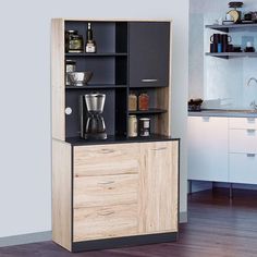 an open cabinet in the corner of a kitchen with coffee maker and other items on it