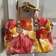 Coach Ashley Multicolor Floral Print Satchel Handbag Purse Tote Brand New With Tags Features: Coach Creed A1349-F21885 Multi-Color Canvas With Leather Trim Zipper Closure Silvertone Hardware Coach Hangtag Inside Zipper Pocket & Slip Pocket Inside Beige Satin Lining Never Used, From Smoke/Pet-Free Environment Measurements: 8.5" Height 4.5" Wide 12" Length 5" Handles Drop Detachable 18” Shoulder Strap Coach Yellow Double Handle Bag, Pink Satchel With Top Carry Handle For Spring, Summer Pink Satchel With Removable Pouch, Spring Coach Shoulder Bag With Removable Pouch, Coach Spring Satchel Bag, Coach Shoulder Bag With Removable Pouch For Spring, Spring Coach Top Handle Bag, Spring Coach Satchel Bag, Coach Top Handle Bag For Spring