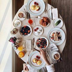 a person sitting at a table with food on it