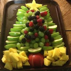 a christmas tree made out of fruit on a tray