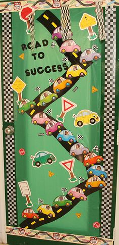 a green door decorated with cars and checkered paper that says road to success on it