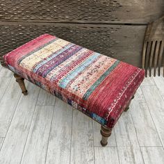 a bench with a multicolored rug on it