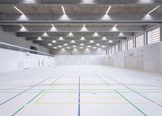 an empty warehouse with white walls and colorful lines on the floor