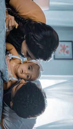 a woman holding a baby in her arms