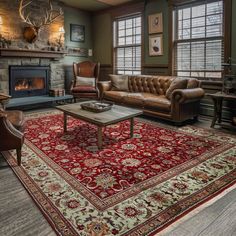 a living room filled with furniture and a red rug on top of a wooden floor