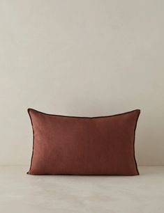 a brown pillow sitting on top of a white table