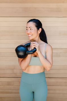 a woman holding a pair of boxing gloves