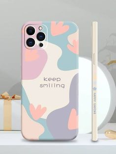 a phone case with the words keep smiling on it next to a cup and pen