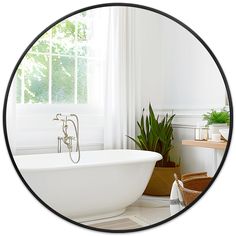 a bathroom with a tub and plants in it