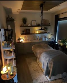 a bed sitting in a bedroom next to a shelf filled with candles and other items