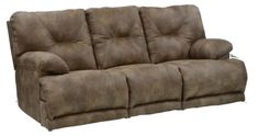 the reclining sofa is brown and has two pillows on it's back end