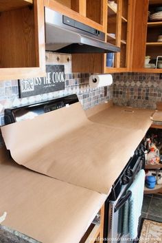 the kitchen counter is covered with paper and ready to be put into the oven for baking