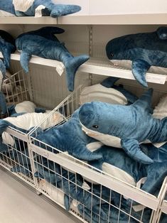 stuffed sharks are on display in the store for children's clothing to wear as they sleep