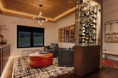 a living room filled with furniture and a wine rack