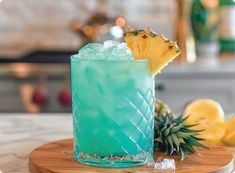 a blue cocktail with pineapple garnish sits on a cutting board